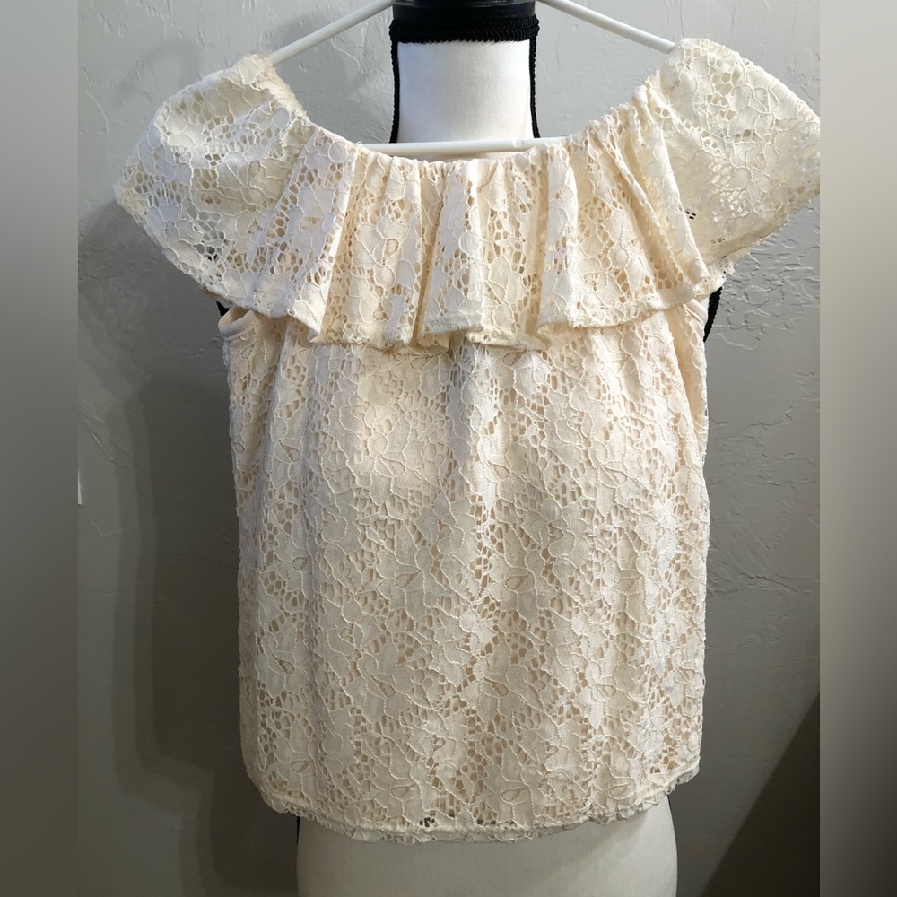 Cream colored lace blouse.